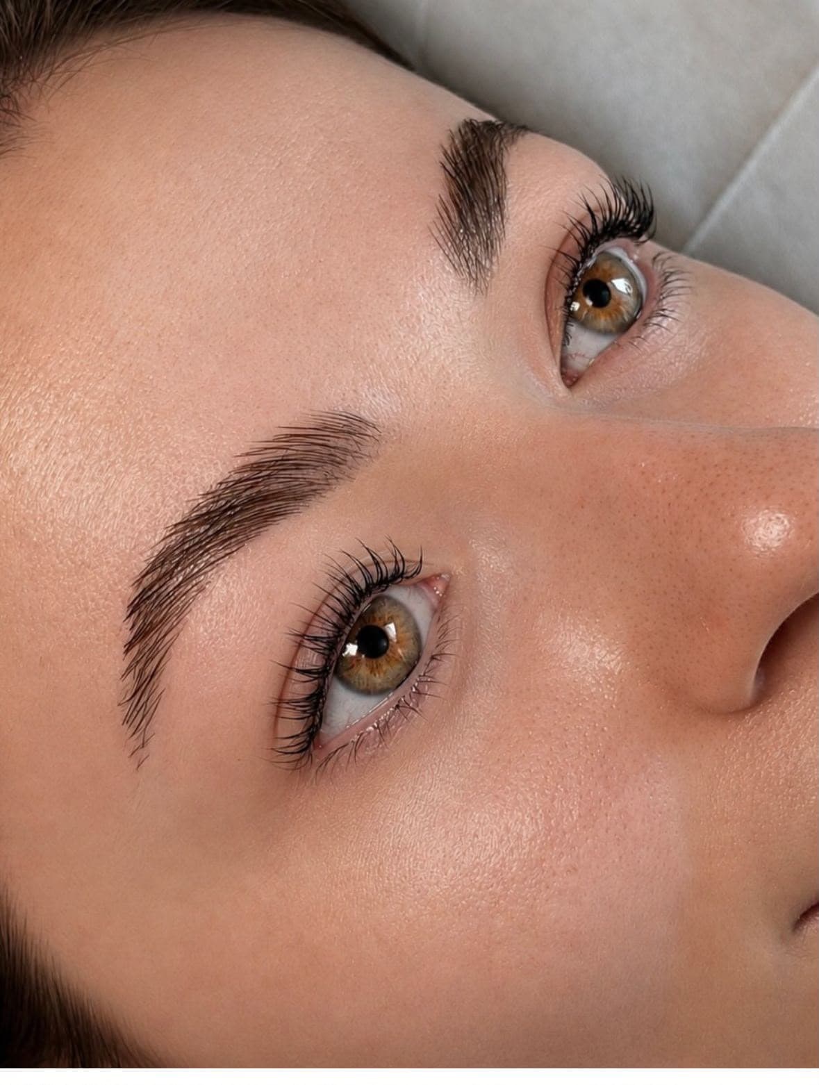 Close-up of softly lifted lashes and naturally shaped brows