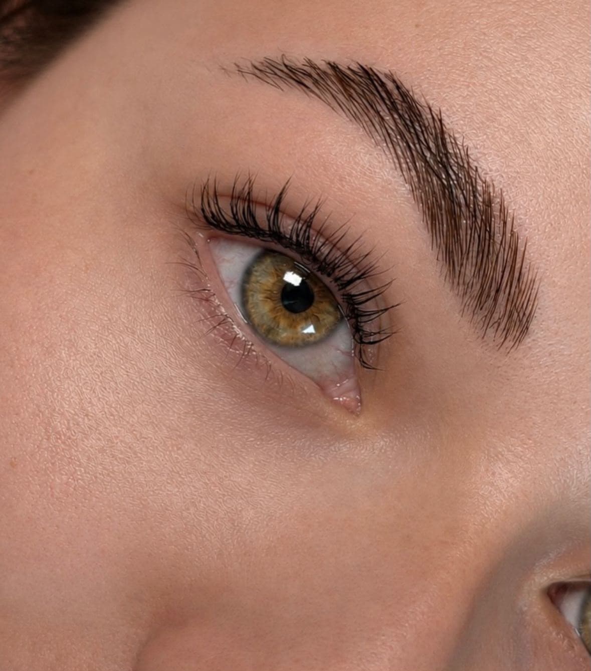 Close-up of wispy lashes paired with a softly defined brow